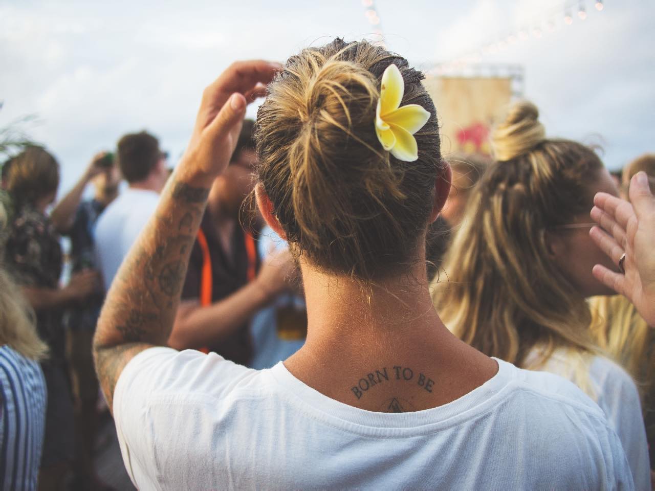 behind a person looking upstage. Tattoo on neck says Born to Be