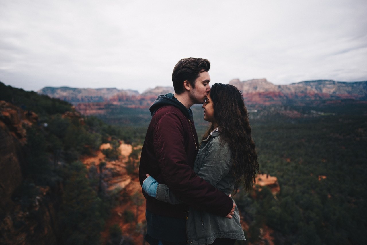 young couple hugging by scenic outpost